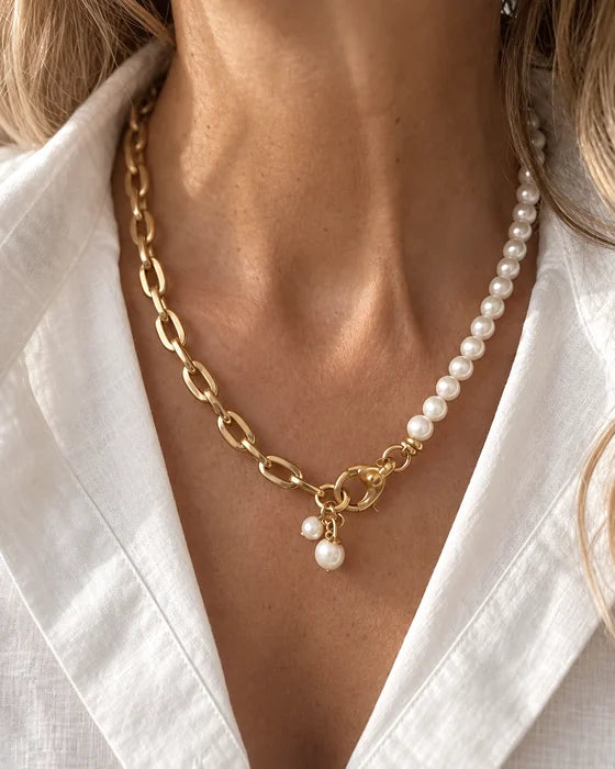Gold chain and white bead necklace worn with an ivory shirt